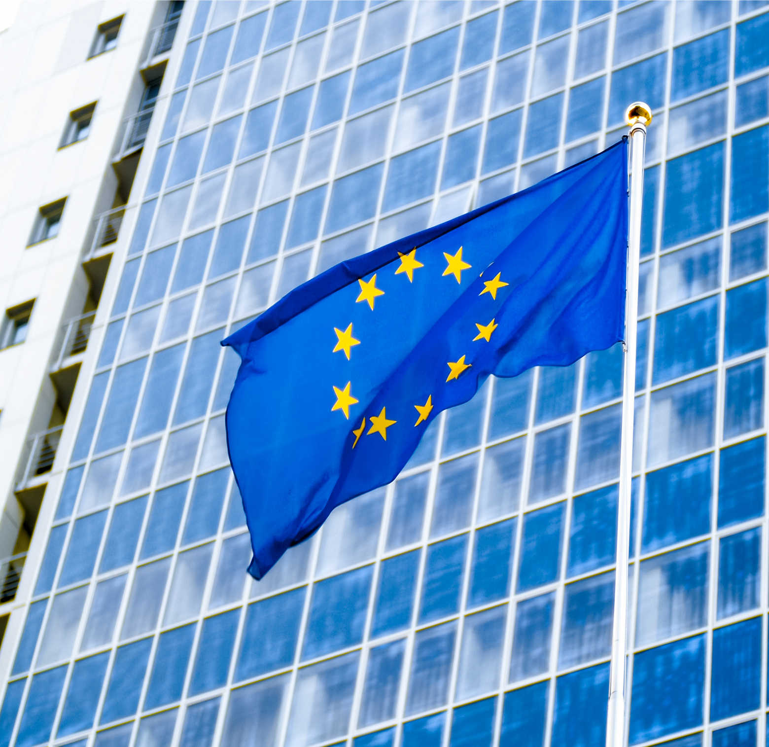 eu flag waving against glass facade portrait